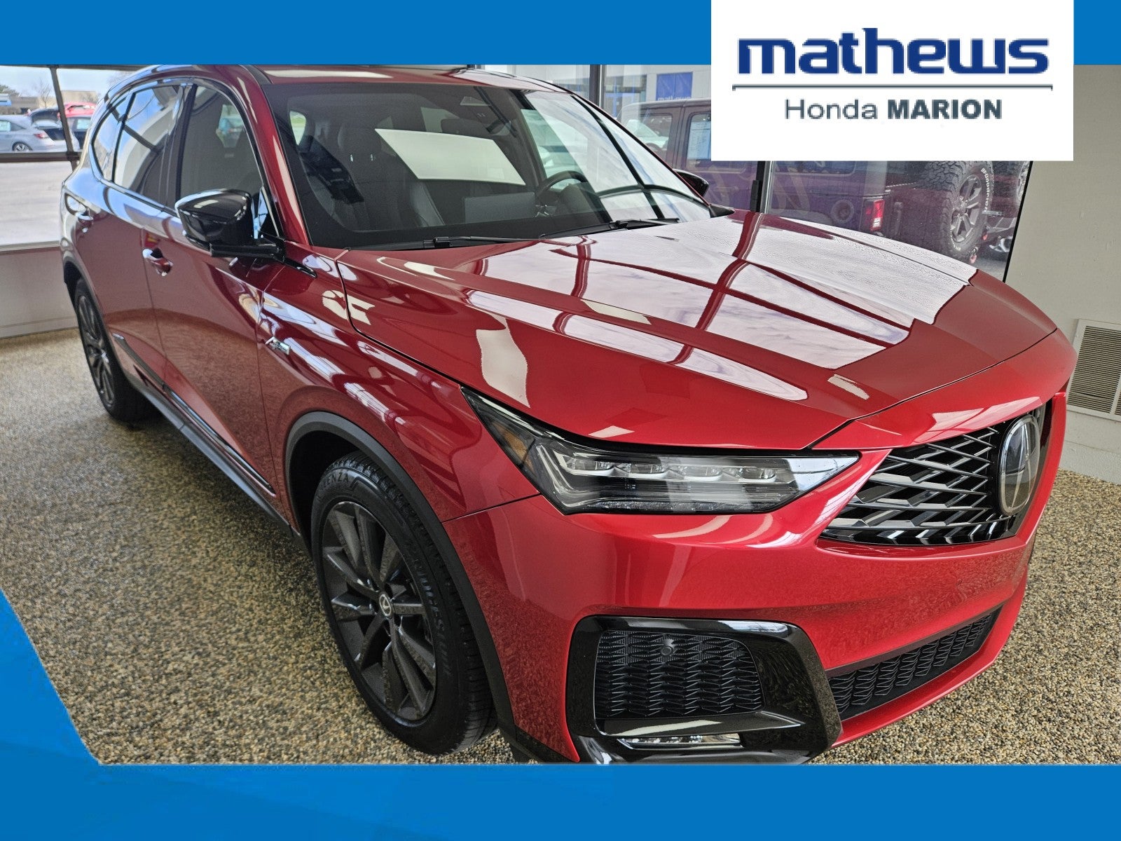 2025 Acura MDX w/A-Spec Package in Performance Red Pearl — front three-quarter view
